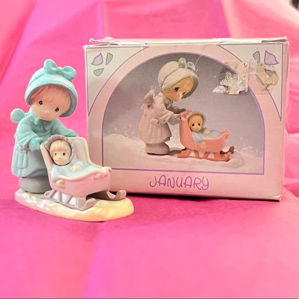 Enesco precious moments miniature for month of January.
